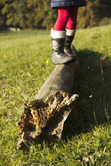 Germany, Bavaria, Landshut, girl balancing on log - YFF000261