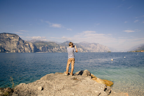 Italy, Veneto, Brenzone sul Garda, Boy taking pictures with smartphone - LVF002162