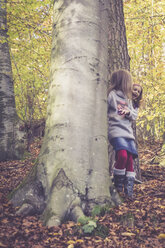 Two little girls playing hide and seek in the wood - SARF001019