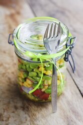 Vegetable salad with corn, fava beans and red radishes in preserving jar - HAWF000504