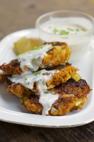 Savory Pumpkin Fritters with spicy soy yogurt sauce with chives stock photo