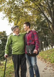 Senior man and adult grandson in park - UUF002636