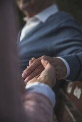 Daughter holding hand of senior man - UUF002677