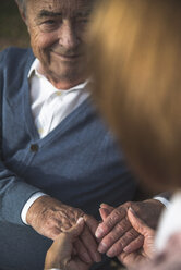 Daughter holding hand of senior man - UUF002678