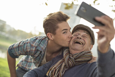 Happy senior man taking a selfie with grandson - UUF002720