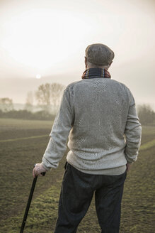 Senior man in rural landscape looking at view - UUF002709