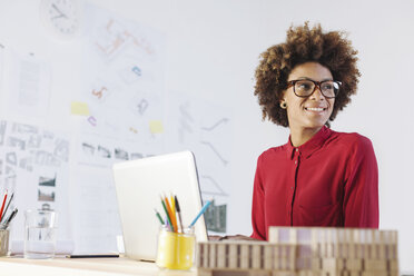 Portrait of smiling young female architect at her office - EBSF000347