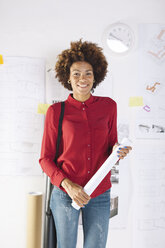 Happy young female architect at her office - EBSF000356