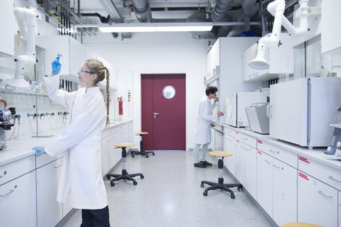 Two female scientists working in a pharmacy research laboratory - SGF001050