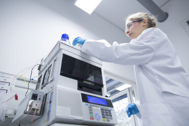 Young female scientist working in a pharmacy research laboratory - SGF001043