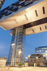 Germany, Cologne, crane houses and old warehouses at Zollhafen at dusk - MEM000477