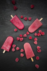 Raspberry ice lollies and raspberries on black ground - LVF002204