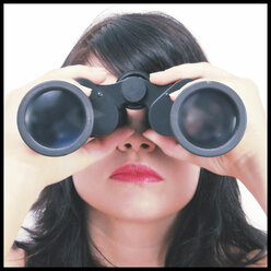 Woman looking through binoculars - HOHF001116