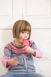 Portrait of little girl eating raspberry ice lolly - LVF002292