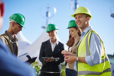 Business partners having a meeting with wind turbine engineer - ZEF002247