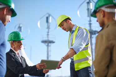 Business partners having a meeting with wind turbine engineer - ZEF002250