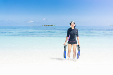 Maldives, Ari Atoll, young female diver coming out of water - FLF000583