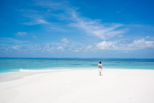 Maledives, Ari Atoll, young woman walking at dream beach - FLF000589