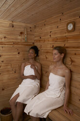 Zwei junge Frauen sitzen in einer Sauna - FSF000357