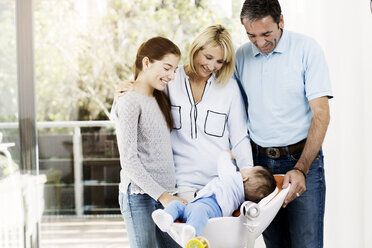 Parents and daughter looking after baby boy - GDF000583