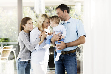 Parents and daughter looking after baby boy - GDF000586