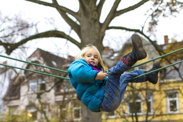 Little girl climbing on playground equipment - JFEF000537