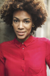 Portrait of smiling young woman wearing red blouse - EBSF000373