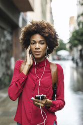 Portrait of young woman hearing music with earphones - EBSF000374