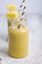 Glasses of pineapple smoothie on doily - ODF000874