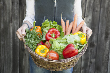 Woman holding basket with vegetables - RBF001975