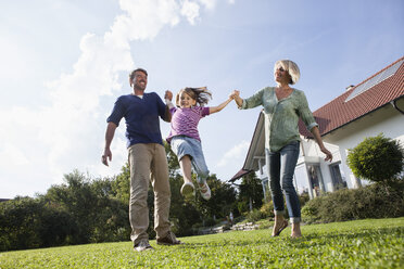 Happy family playing in garden - RBF002004