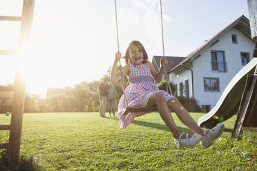 Happy girl on swing in garden - RBF002015