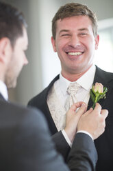 Groom getting ready for wedding with best man - ZEF002544