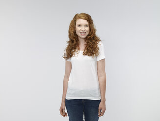Portrait of smiling young woman in front of white background - RH000386