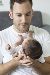 Young father holding his newborn son - OJF000084