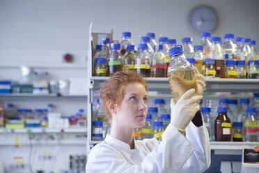 Young female natural scientist working in biochemistry laboratory - SGF001148