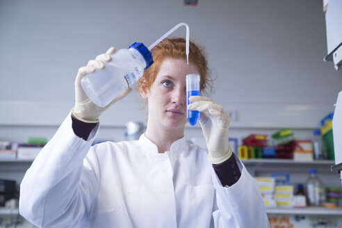 Young female natural scientist working in biochemistry laboratory - SGF001126