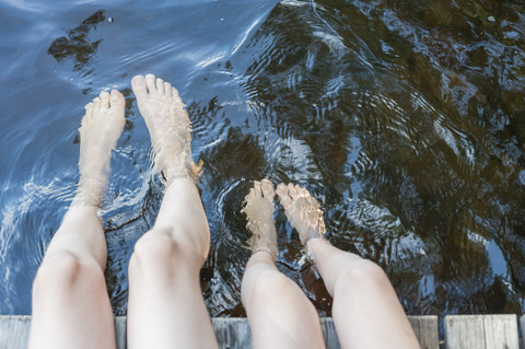Finland, lake Saimaa, children splashing feet in water stock photo