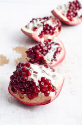 Four pieces of pomegranates on white wood - ODF000891