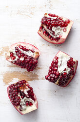 Four pieces of pomegranates on white wood - ODF000890