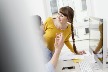 Happy couple in home office - FMKF001429