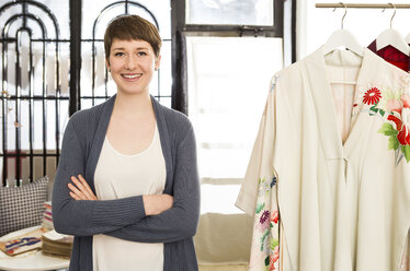 Portrait of smiling female fashion designer at her studio - DISF001138