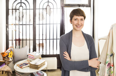 Portrait of smiling female fashion designer at her studio - DISF001133