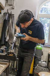 Knife maker in workshop at work - TCF004401