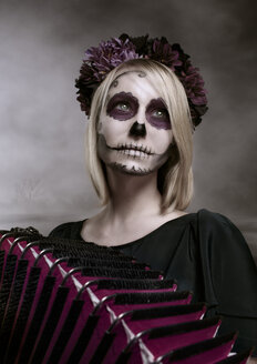 Portrait of woman with sugar skull makeup and accordion - NIF000025