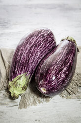 Two organic aubergines on cloth - SARF001128