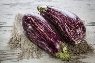 Two organic aubergines on cloth - SARF001129