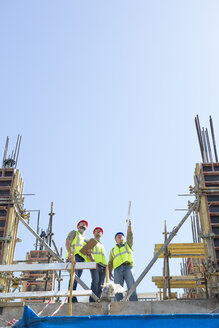 Three construction workers in construction site - ZEF001946