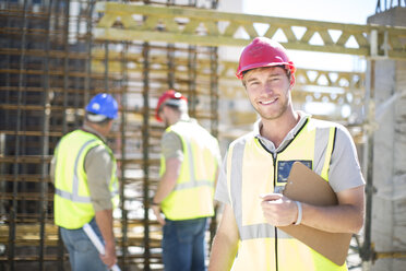 Portrait of smiling construction worker in construction site - ZEF001591