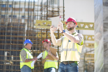 Bauarbeiter mit digitalem Tablet auf einer Baustelle - ZEF001947